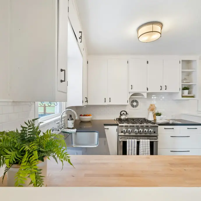 white wooden kitchen cupboards and gray gas stove